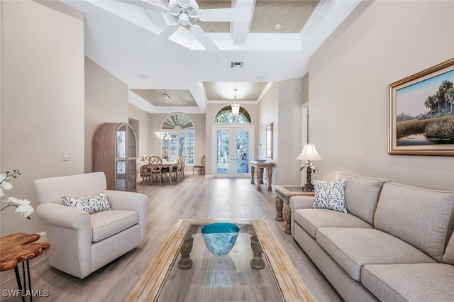 living area featuring visible vents, coffered ceiling, light wood-style flooring, french doors, and beam ceiling