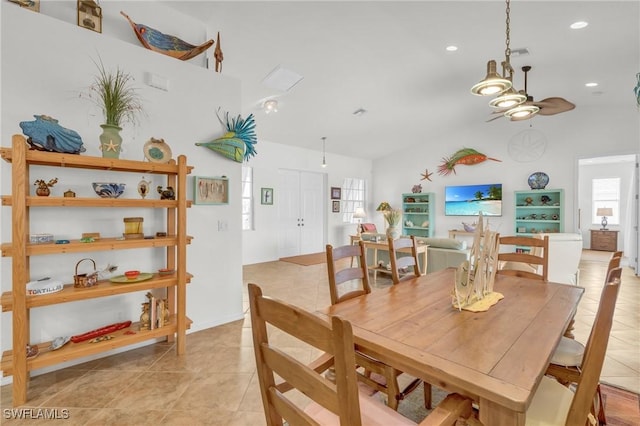 dining space with lofted ceiling, plenty of natural light, and light tile patterned flooring