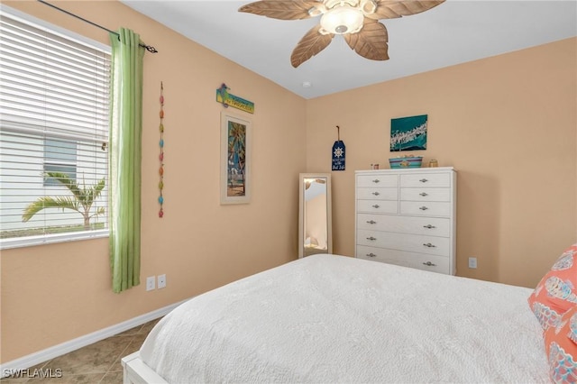 bedroom featuring ceiling fan, baseboards, and light tile patterned flooring