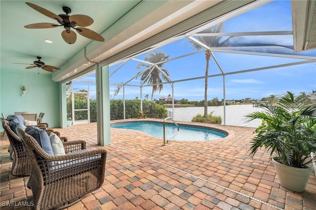 pool featuring a ceiling fan, a lanai, a water view, and a patio