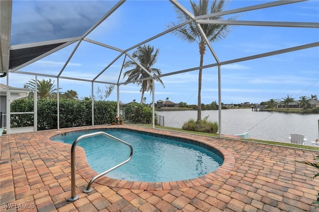 outdoor pool featuring a water view, glass enclosure, and a patio