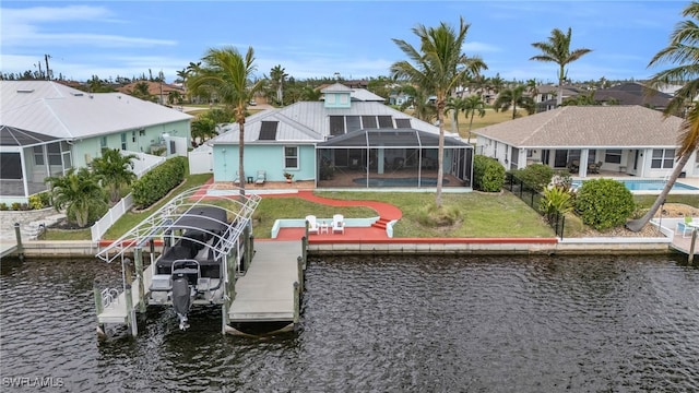 rear view of house with an outdoor pool, boat lift, a residential view, a lanai, and a water view