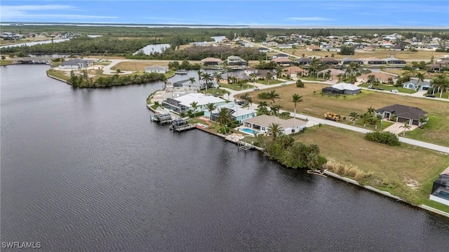 drone / aerial view featuring a residential view and a water view