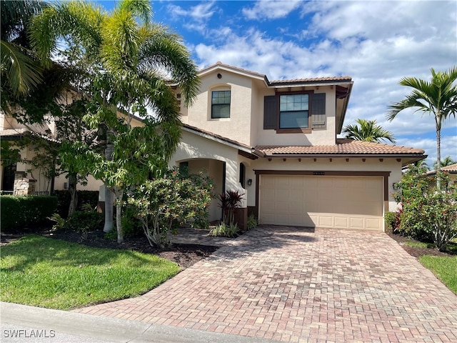 mediterranean / spanish-style home with a garage