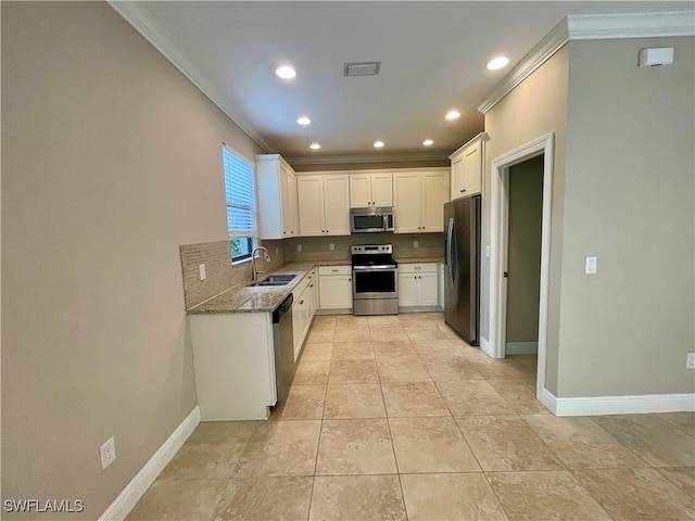 kitchen featuring stone counters, sink, stainless steel appliances, white cabinets, and ornamental molding