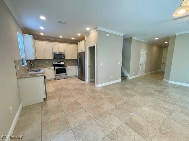 kitchen with white cabinets, crown molding, sink, light stone counters, and stainless steel appliances