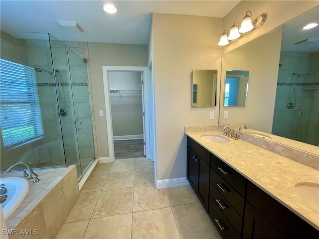 bathroom with tile patterned floors, vanity, and separate shower and tub