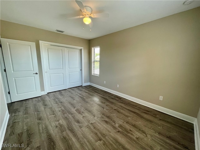 unfurnished bedroom featuring wood-type flooring, a closet, and ceiling fan