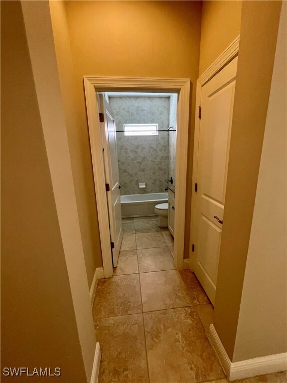 corridor with light tile patterned flooring