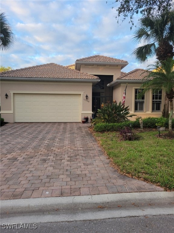 view of front facade with a front yard and a garage