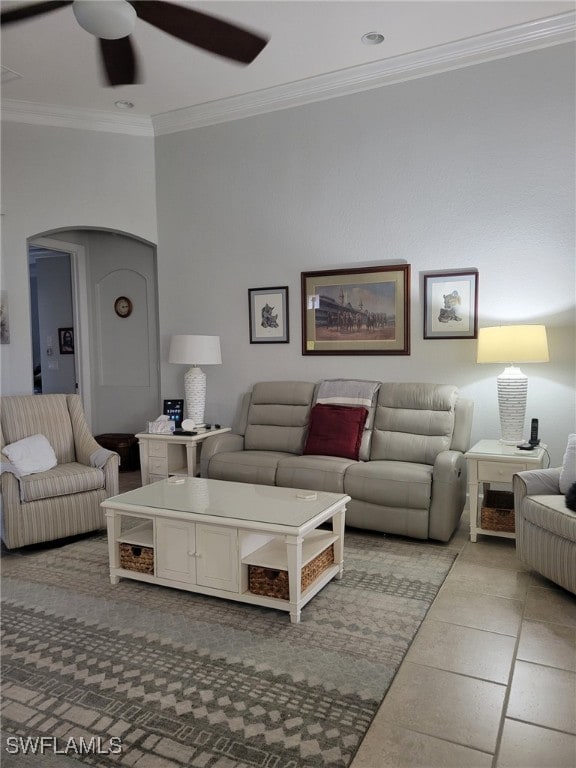 tiled living room featuring ceiling fan and crown molding