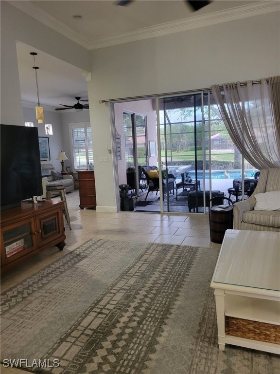 living room featuring tile patterned flooring, ceiling fan, and ornamental molding