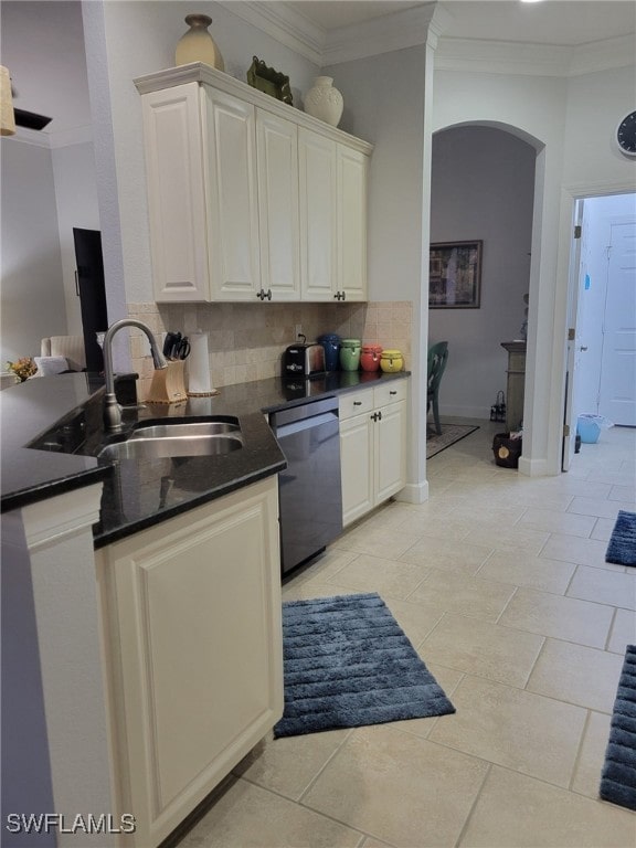 kitchen with decorative backsplash, light tile patterned floors, stainless steel dishwasher, and sink