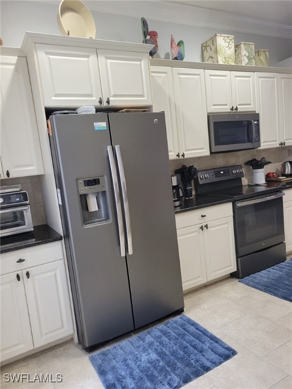 kitchen featuring white cabinets, decorative backsplash, stainless steel appliances, and light tile patterned flooring