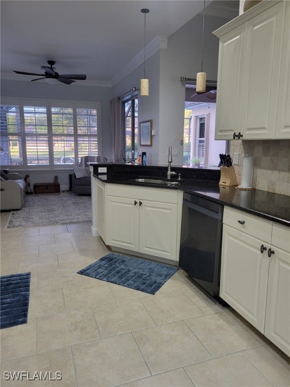 kitchen with sink, decorative backsplash, black dishwasher, a healthy amount of sunlight, and white cabinetry