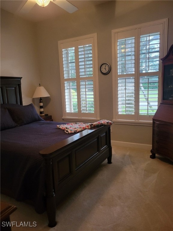 carpeted bedroom with ceiling fan