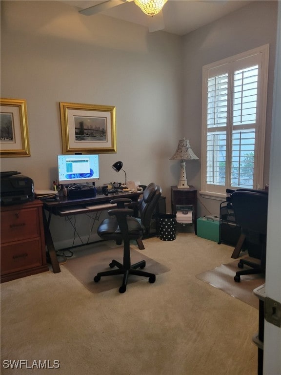 office space featuring carpet floors, ceiling fan, and a healthy amount of sunlight