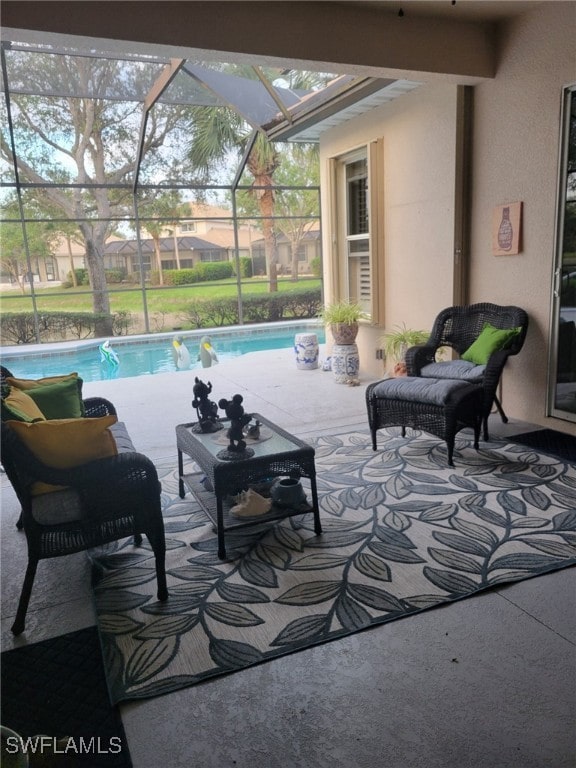 view of swimming pool featuring a lanai and a patio