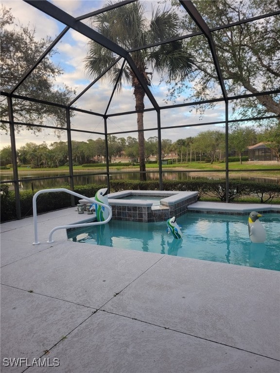 view of swimming pool featuring a patio area, a lanai, an in ground hot tub, and a water view