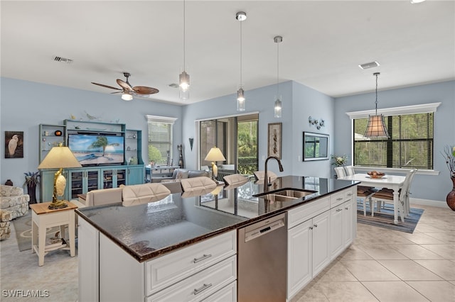 kitchen with dishwasher, white cabinetry, plenty of natural light, and sink