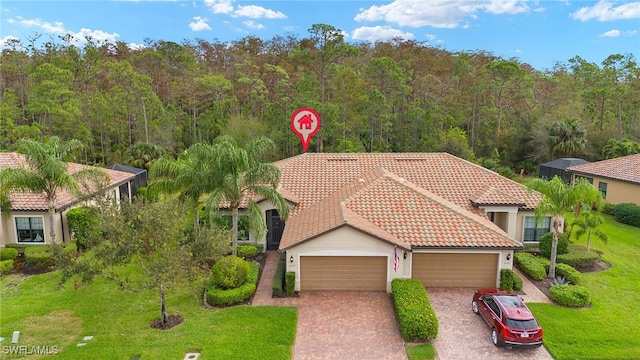 view of front of house with a front yard and a garage