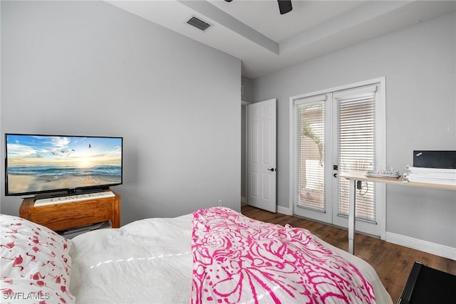 bedroom featuring baseboards, dark wood finished floors, visible vents, and access to exterior