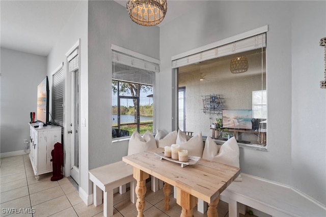 dining room featuring light tile patterned floors and baseboards