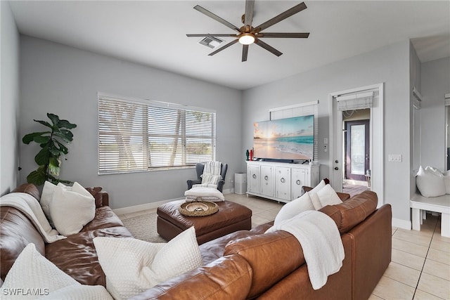 tiled living room with ceiling fan