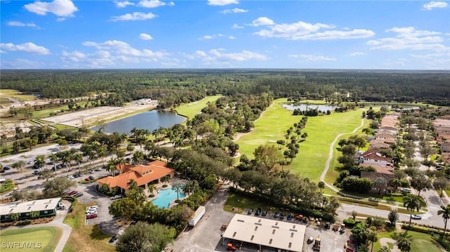 aerial view with a forest view, golf course view, and a water view