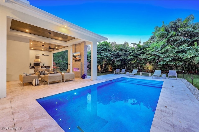 view of swimming pool featuring an outdoor living space, ceiling fan, and a patio area