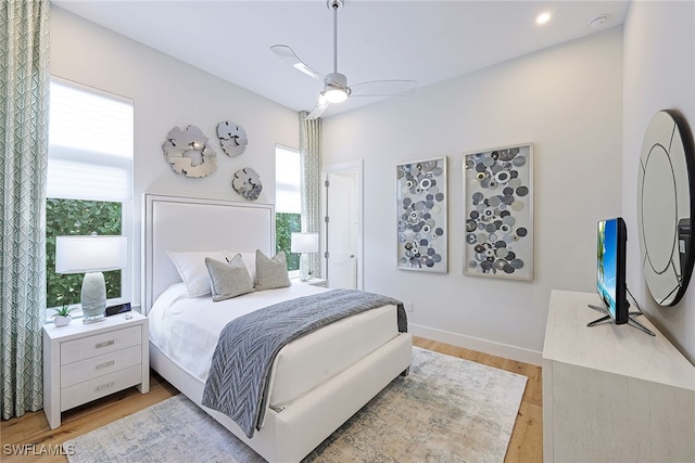 bedroom with light hardwood / wood-style floors and ceiling fan