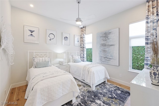 bedroom with ceiling fan and light hardwood / wood-style floors