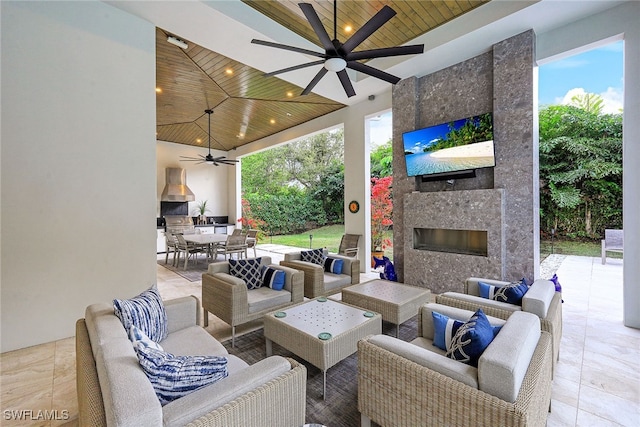 view of patio featuring an outdoor living space with a fireplace and ceiling fan