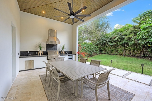 view of patio / terrace with grilling area, ceiling fan, and an outdoor kitchen