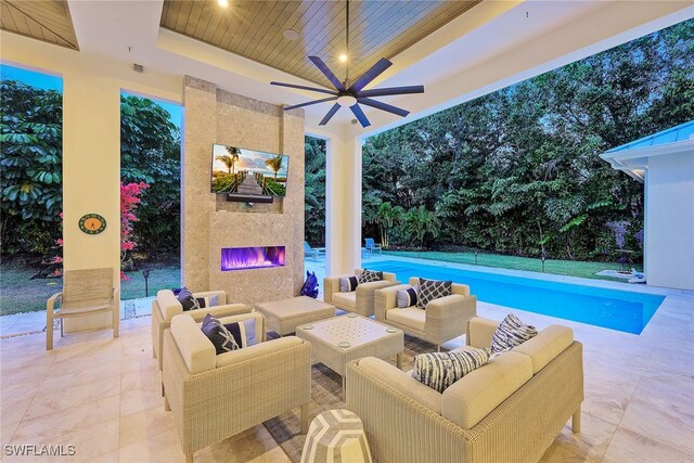 view of pool with ceiling fan, a large fireplace, and a patio area