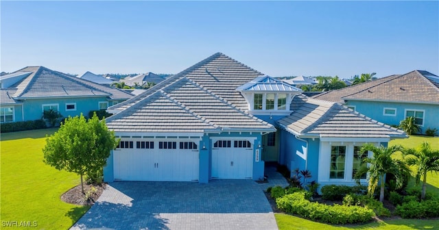 view of front of house with a front yard and a garage