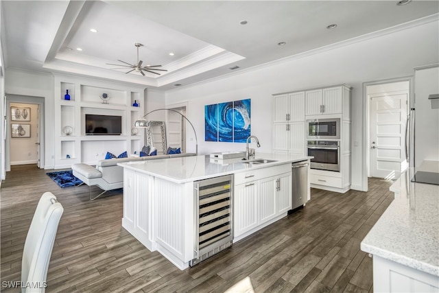 kitchen with wine cooler, white cabinetry, sink, and stainless steel appliances