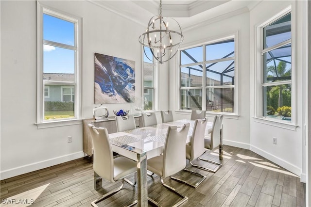 6399 Warwick Ave, Naples, FL 34113 - dining area featuring a chandelier, wood finished floors, baseboards, and ornamental molding