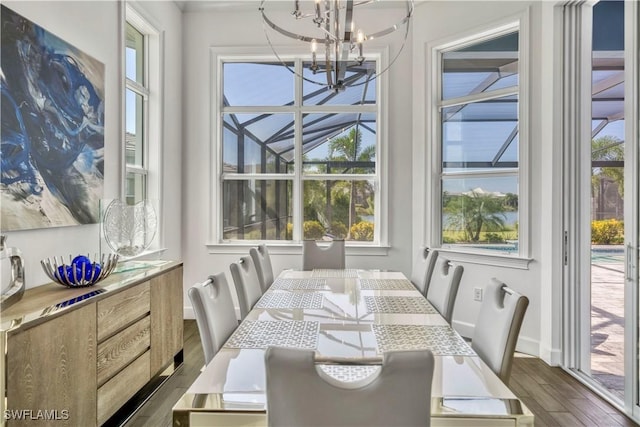 6399 Warwick Ave, Naples, FL 34113 - dining area with a chandelier, dark wood-style flooring, and baseboards