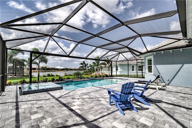 view of swimming pool with an in ground hot tub, a water view, glass enclosure, and a patio area