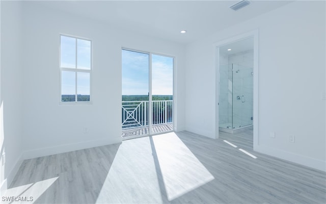 empty room with light hardwood / wood-style flooring