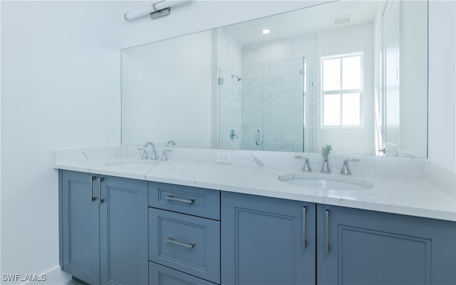 bathroom with vanity and a shower with shower door