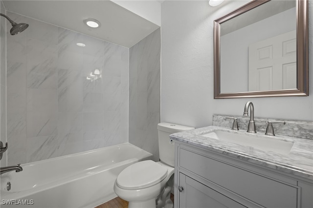 full bathroom featuring vanity, toilet, and tiled shower / bath