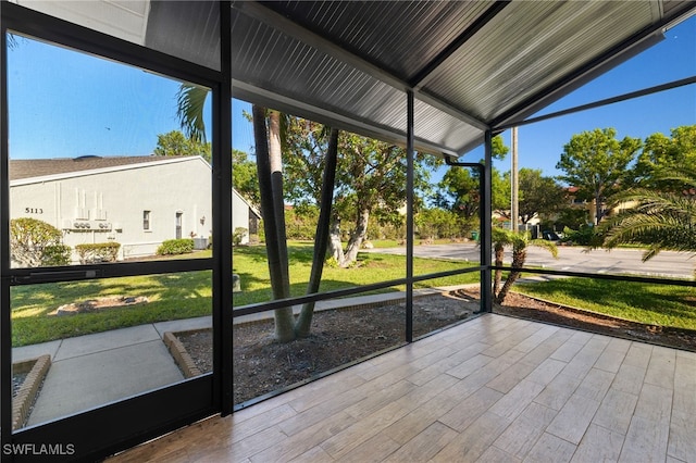 unfurnished sunroom with vaulted ceiling