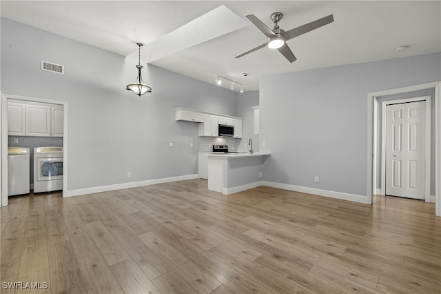 unfurnished living room featuring ceiling fan, light wood-type flooring, separate washer and dryer, and sink