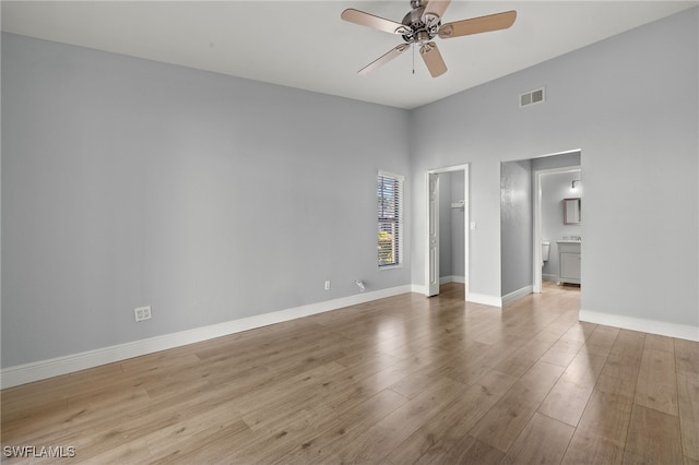 empty room with light wood-type flooring and ceiling fan