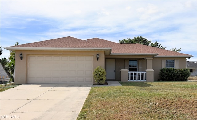 ranch-style house with covered porch, a garage, and a front lawn