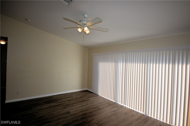 empty room with ceiling fan and dark hardwood / wood-style floors