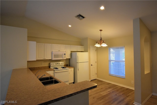 kitchen featuring pendant lighting, white appliances, white cabinets, sink, and kitchen peninsula