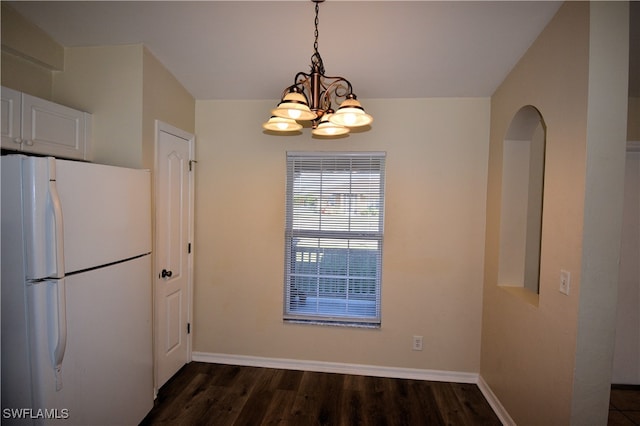 kitchen featuring a notable chandelier, dark hardwood / wood-style floors, white refrigerator, and white cabinets